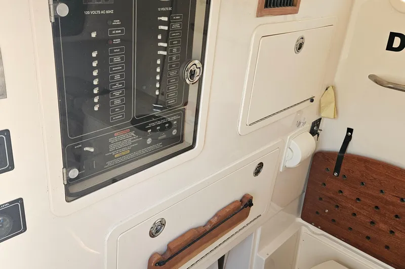 Slide: The Image of Electrical panel and storage compartments on a 2022 Grady-White Canyon 336 boat. - 29