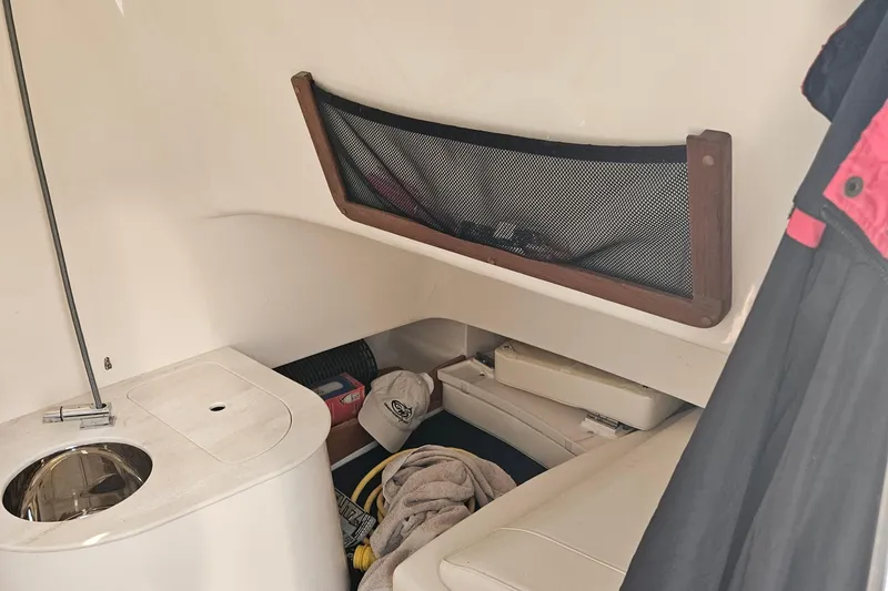 Slide: The Image of 2022 Grady-White Canyon 336 cabin interior with storage and seating area. - 30