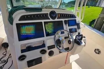 Slide: The Image of 2022 Grady-White Canyon 336 boat dashboard with advanced navigation and control systems. - 33