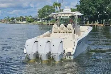 Slide: The Image of 2022 Grady-White Canyon 336 boat with four engines on a calm waterway. - 9