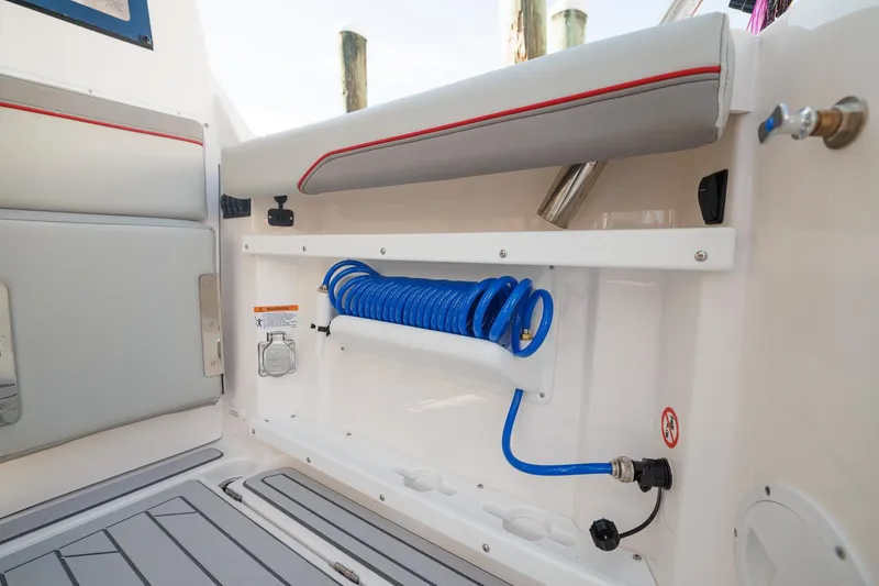 Slide: The Image of Interior of 2026 Solara S-310 SB boat with coiled blue hose and seating. - 19