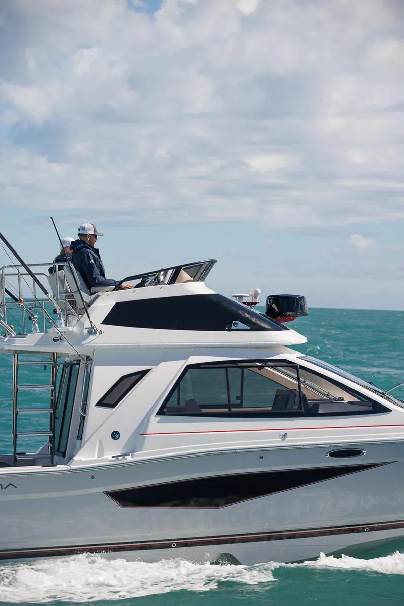 Slide: The Image of 2026 Solara S-310 SB boat cruising on turquoise ocean under cloudy sky. - 3