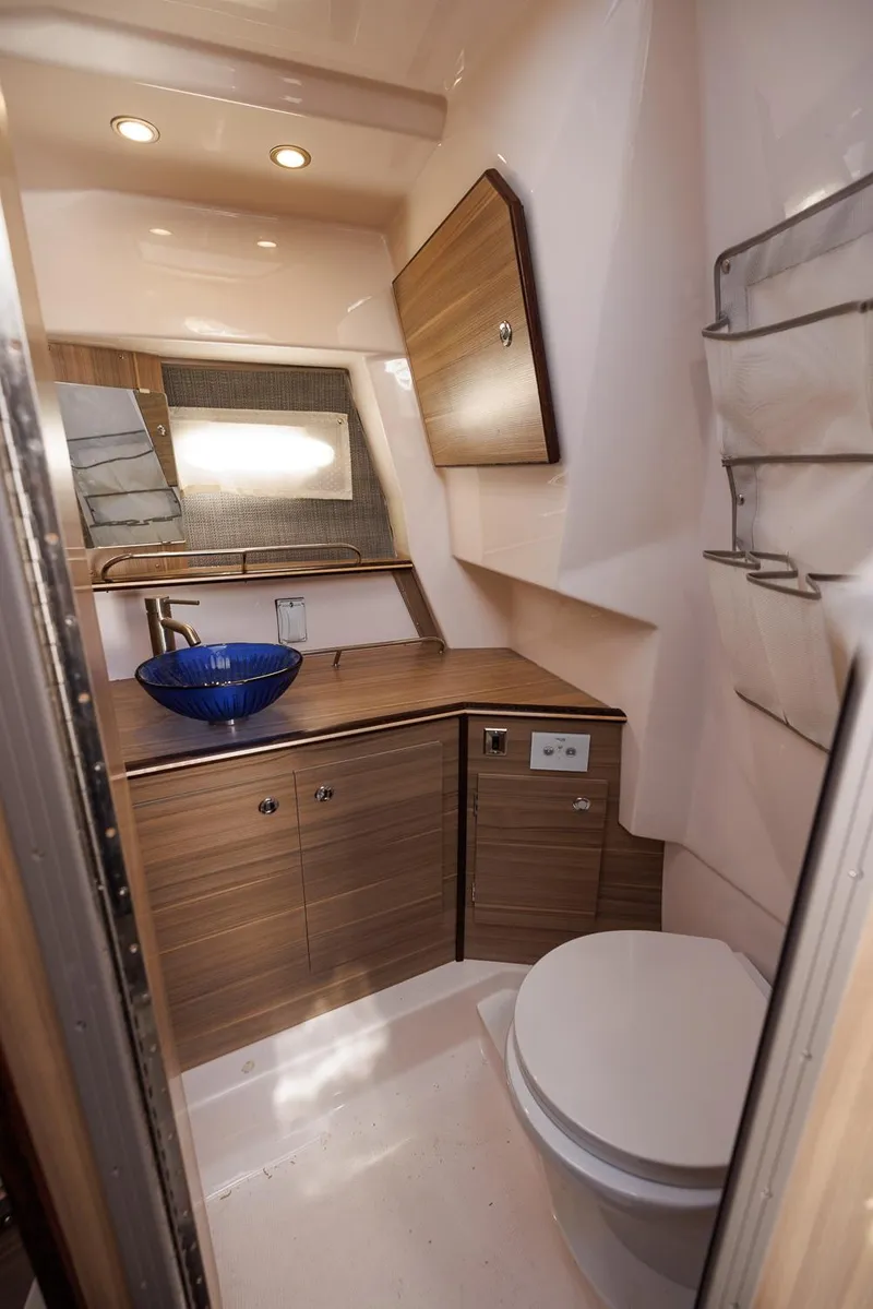 Slide: The Image of Modern bathroom in 2026 Solara S-310 SB boat with wood cabinetry and blue glass sink. - 43