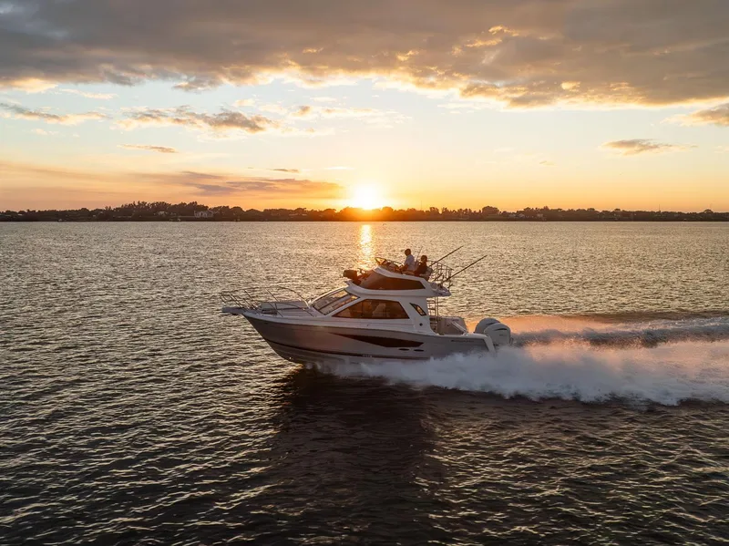 Slide: The Image of Solara S-310 SB boat cruising at sunset, 2026 model, on open water. - 8