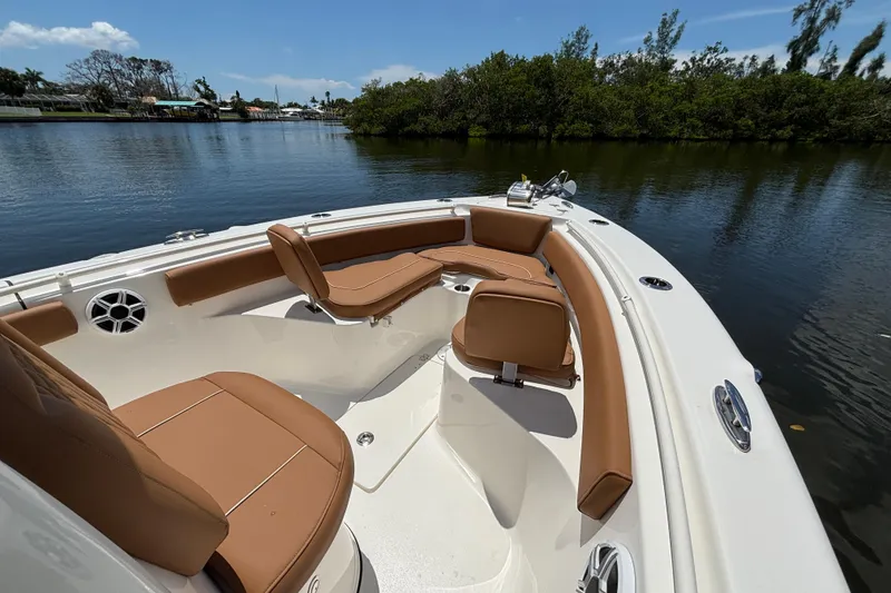 Slide: The Image of 2026 Key West 239 FSR boat with tan seating on a calm river. - 14