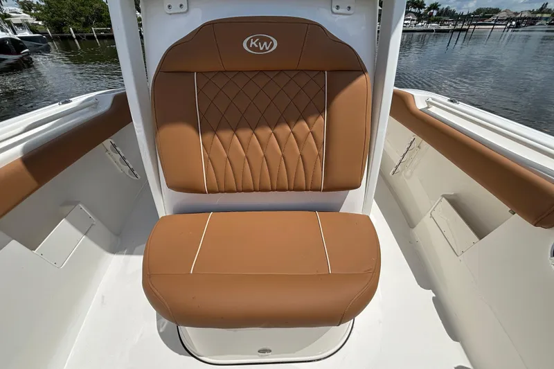 Slide: The Image of Brown cushioned seat on 2026 Key West 239 FSR boat, docked by the water. - 16