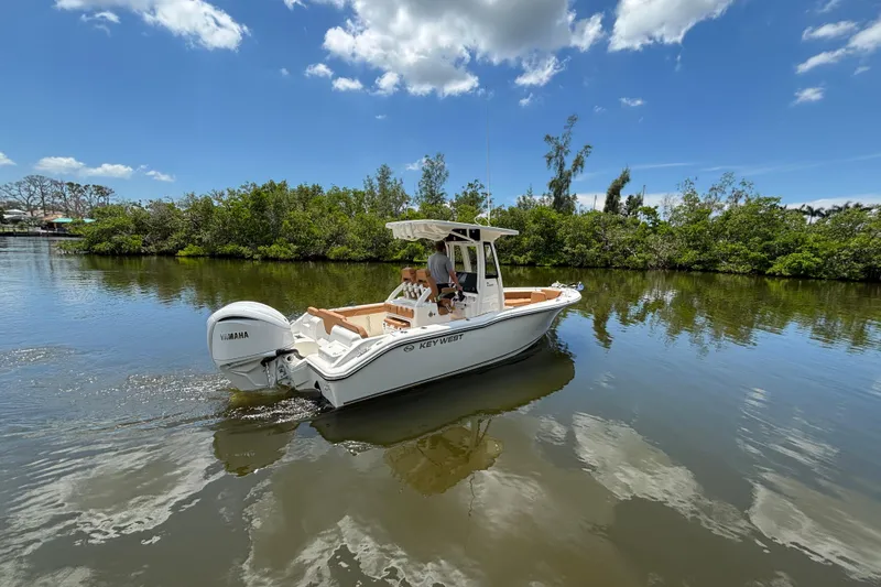 Slide: The Image of 2026 Key West 239 FSR boat cruising on a calm river under a clear blue sky. - 2
