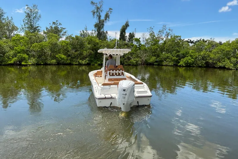 Slide: The Image of 2026 Key West 239 FSR boat cruising on a calm river surrounded by lush greenery. - 3