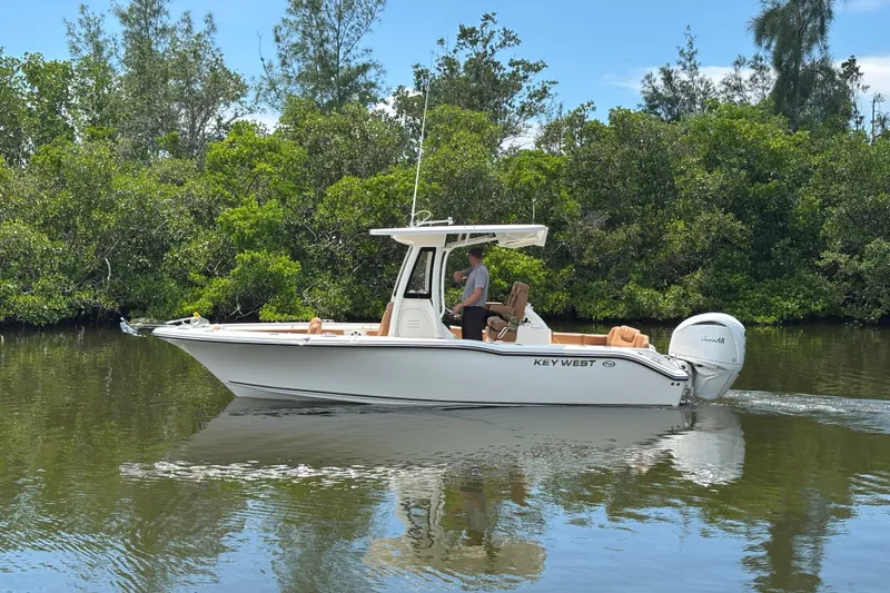 Slide: The Image of 2026 Key West 239 FSR boat cruising on a calm river surrounded by lush greenery. - 5