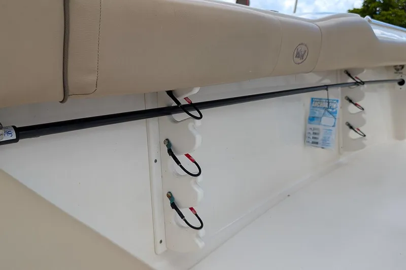 Slide: The Image of 2014 Key West 219 FS boat interior with rod holders and anchor pin storage. - 11