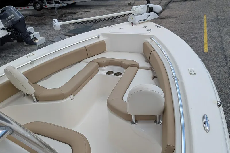 Slide: The Image of 2014 Key West 219 FS boat interior with tan seating and cup holders. - 16