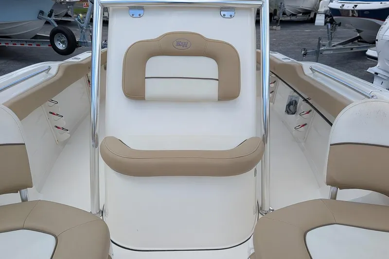 Slide: The Image of 2014 Key West 219 FS boat interior with beige and white seating, stainless steel accents. - 17