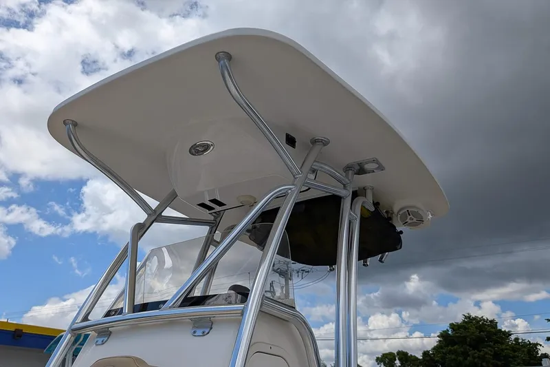 Slide: The Image of 2014 Key West 219 FS boat with T-top against cloudy sky background. - 21