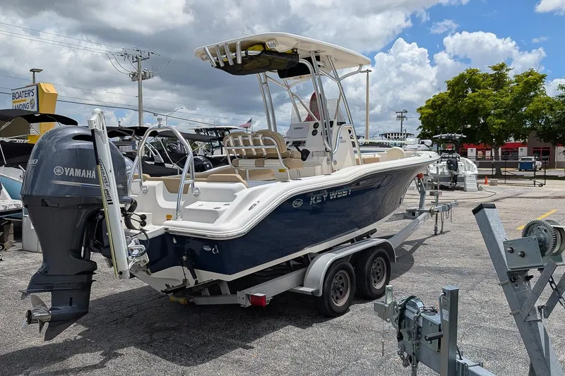 Slide: The Image of 2014 Key West 219 FS boat on trailer with Yamaha engine, parked outdoors. - 3