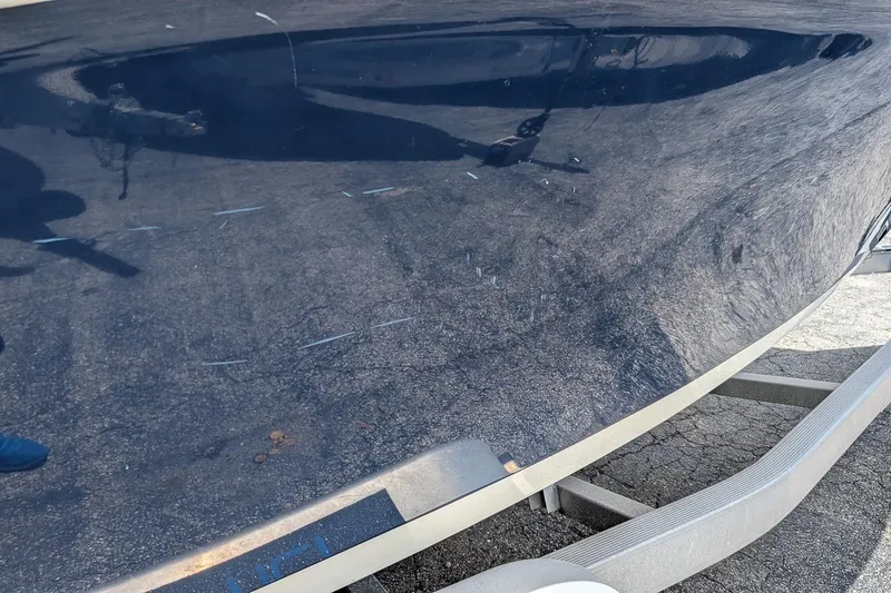 Slide: The Image of 2014 Key West 219 FS boat hull with visible scratches and reflections. - 4