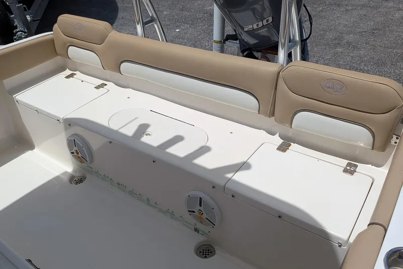 Slide: The Image of 2014 Key West 219 FS boat interior with cushioned seating and storage compartments. - 7