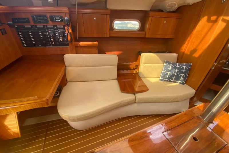 Slide: The Image of Interior of 2003 Hunter 386 sailboat with beige seating and nautical-themed pillow. - 12