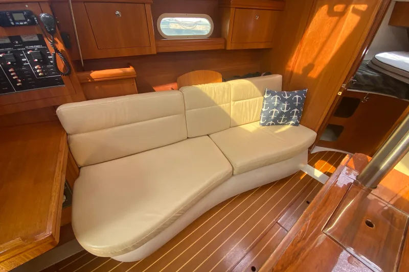 Slide: The Image of Cozy interior of 2003 Hunter 386 sailboat with beige seating and nautical decor. - 13