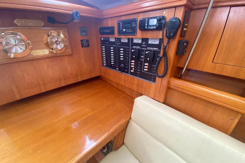 Slide: The Image of Control panel of a 2003 Hunter 386 yacht with wooden interior and navigation instruments. - 15