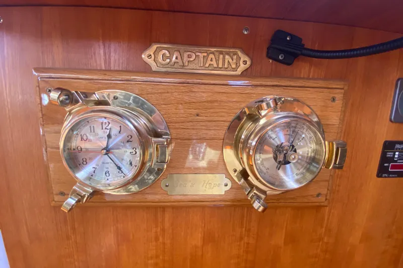 Slide: The Image of Brass clock and barometer on 2003 Hunter 386 yacht's wooden panel. - 17