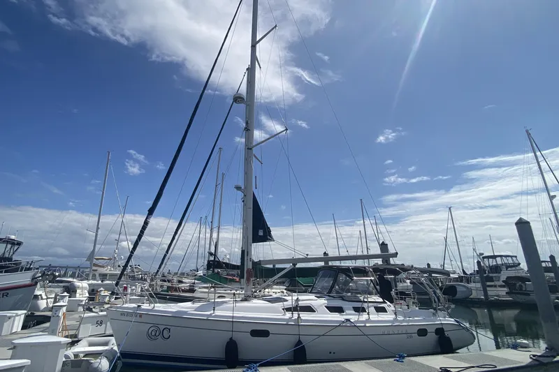 Slide: The Image of 2003 Hunter 386 sailboat docked at marina under clear blue sky. - 2