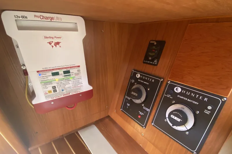 Slide: The Image of Electrical panel in a 2003 Hunter 386 sailboat with battery switches and charger. - 20