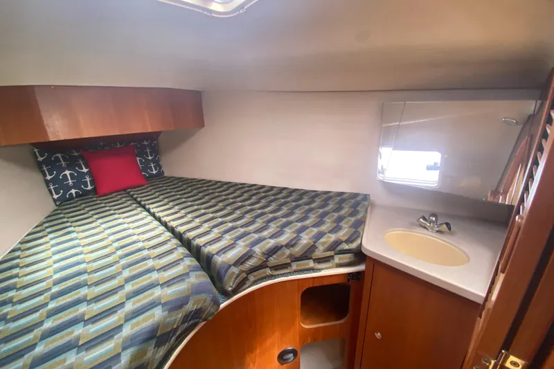 Slide: The Image of Cozy cabin interior of 2003 Hunter 386 yacht with bed and sink. - 22