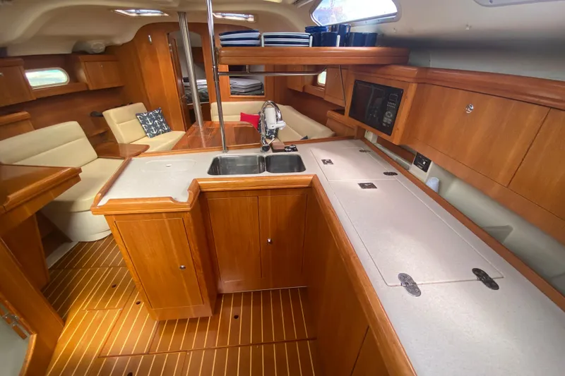 Slide: The Image of Luxurious interior of 2003 Hunter 386 sailboat with wood finish and modern amenities. - 27