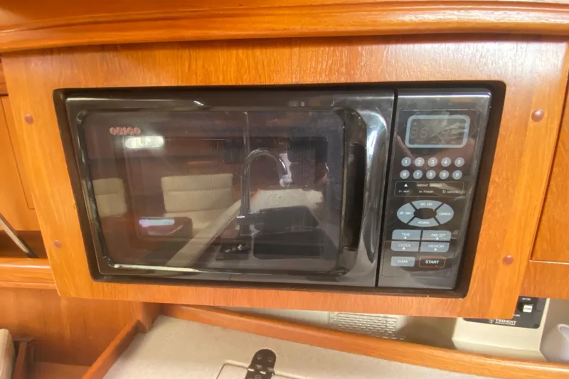 Slide: The Image of Microwave oven in a 2003 Hunter 386 yacht kitchen, set in wooden cabinetry. - 28