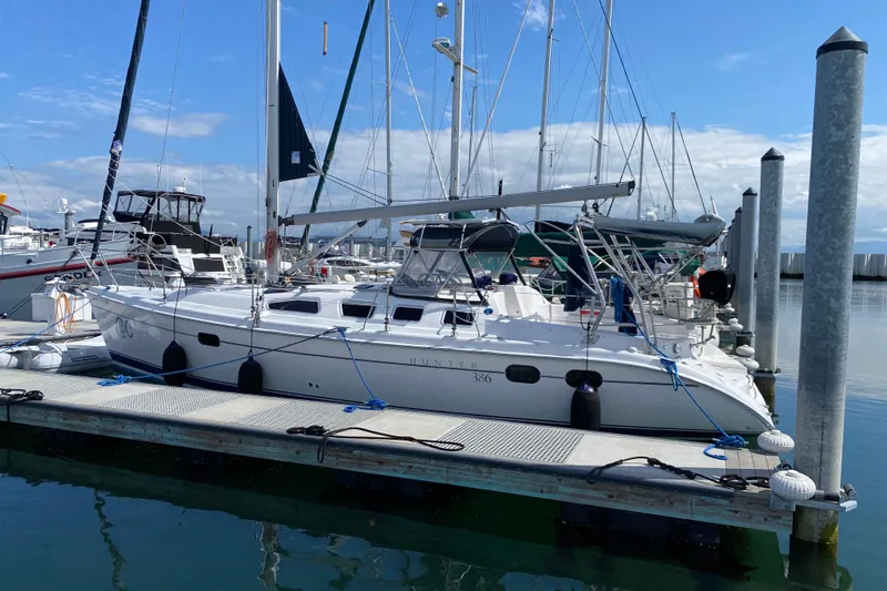 Slide: The Image of 2003 Hunter 386 sailboat docked at marina under clear blue sky. - 3