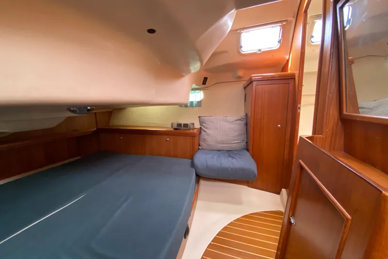 Slide: The Image of Cozy cabin interior of 2003 Hunter 386 sailboat with wooden finishes and seating. - 37