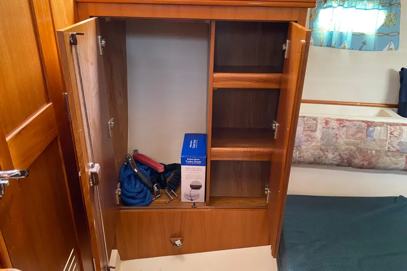 Slide: The Image of Open wooden cabinet in 2003 Hunter 386 yacht with ropes and a turbo dryer. - 38