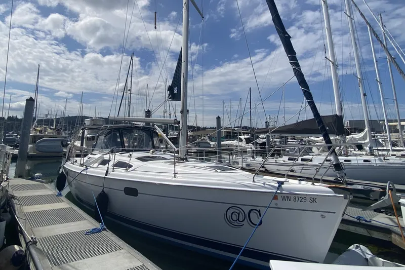 Slide: The Image of 2003 Hunter 386 sailboat docked at marina under cloudy sky. - 4