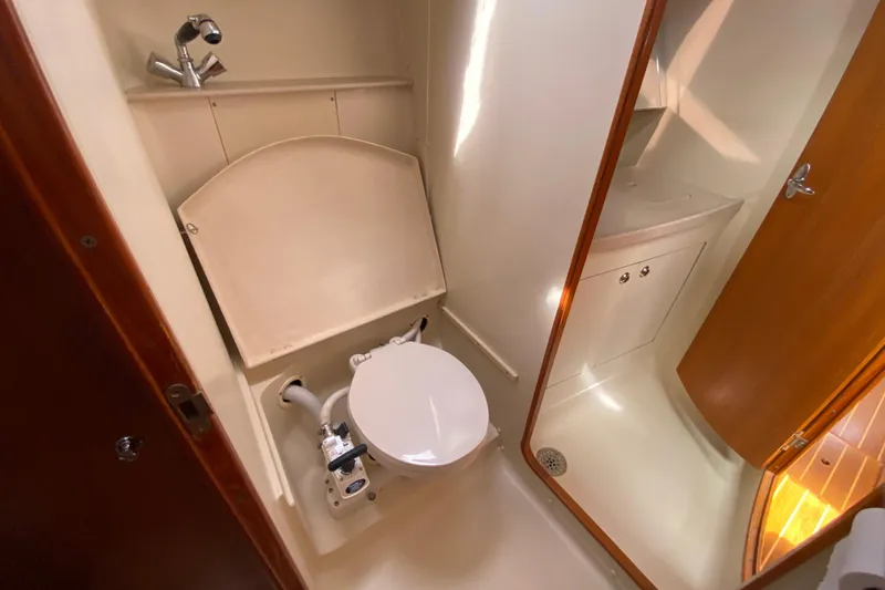 Slide: The Image of 2003 Hunter 386 yacht bathroom with compact toilet and sink. - 42