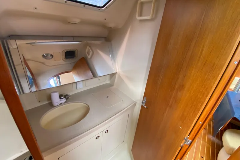 Slide: The Image of Compact bathroom in a 2003 Hunter 386 sailboat with sink and mirror. - 44