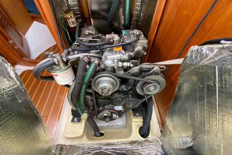 Slide: The Image of Engine compartment of a 2003 Hunter 386 sailboat, showcasing mechanical components and insulation. - 46