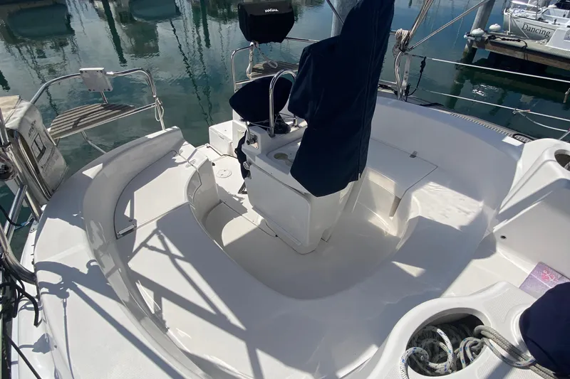 Slide: The Image of 2003 Hunter 386 sailboat cockpit with seating and covered steering wheel. - 5