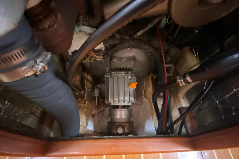 Slide: The Image of Engine compartment of a 2003 Hunter 386 sailboat, showcasing mechanical components and wiring. - 53