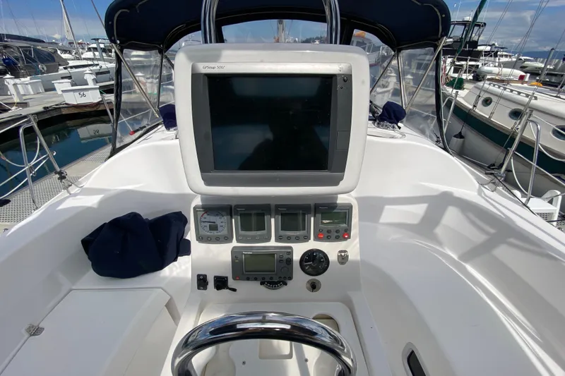 Slide: The Image of Cockpit of 2003 Hunter 386 sailboat with navigation equipment and steering wheel. - 55