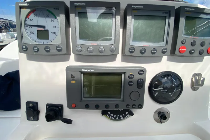 Slide: The Image of Control panel of a 2003 Hunter 386 sailboat with Raymarine instruments. - 58