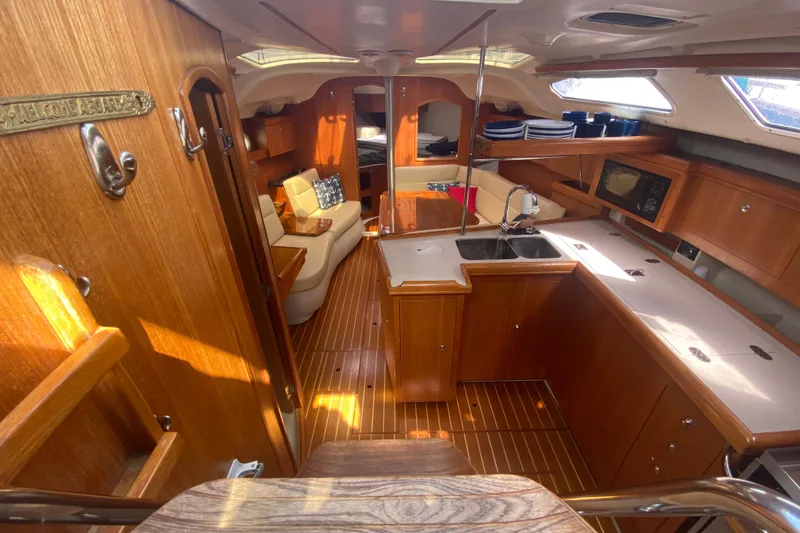 Slide: The Image of Interior of 2003 Hunter 386 sailboat with wooden cabinetry and modern amenities. - 6