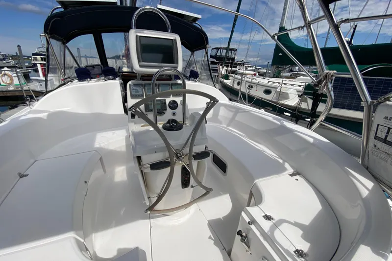 Slide: The Image of Cockpit of 2003 Hunter 386 sailboat with steering wheel and navigation equipment. - 60