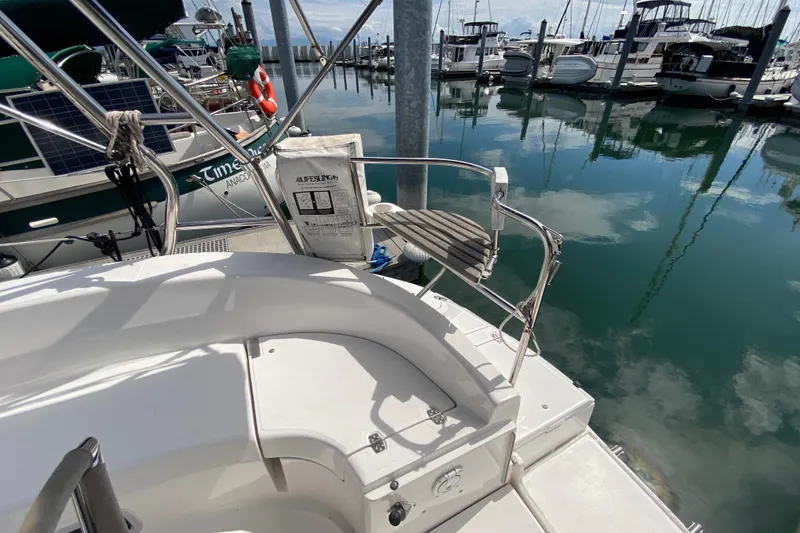 Slide: The Image of Hunter 386 sailboat docked at marina, featuring a lifebuoy and clear reflections on water. - 63