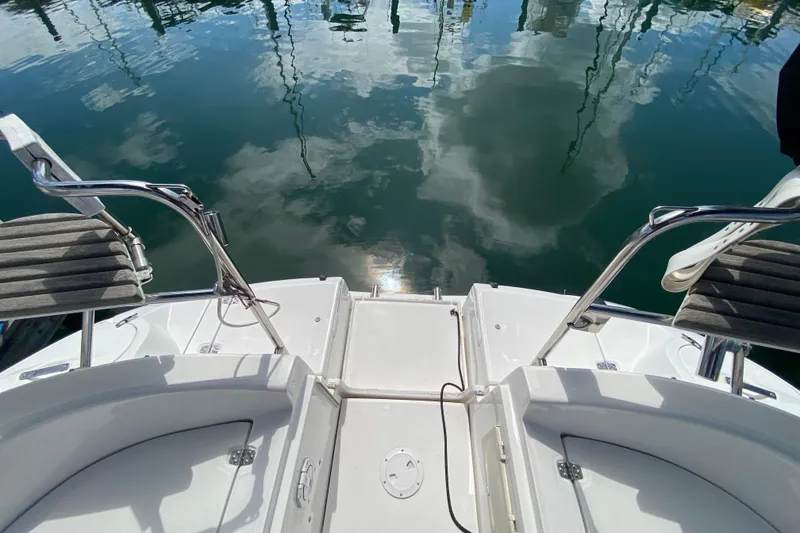 Slide: The Image of 2003 Hunter 386 yacht stern view with water reflection and seating. - 64