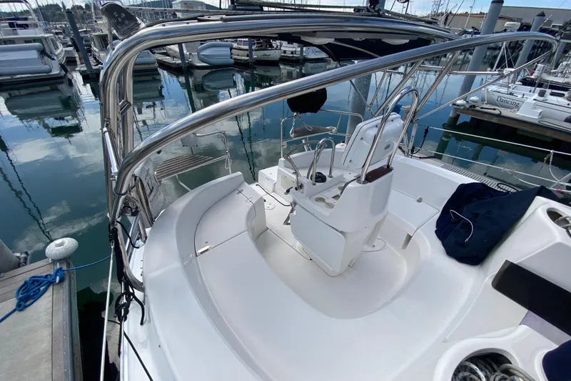 Slide: The Image of 2003 Hunter 386 sailboat cockpit with steering wheel, docked at marina. - 67