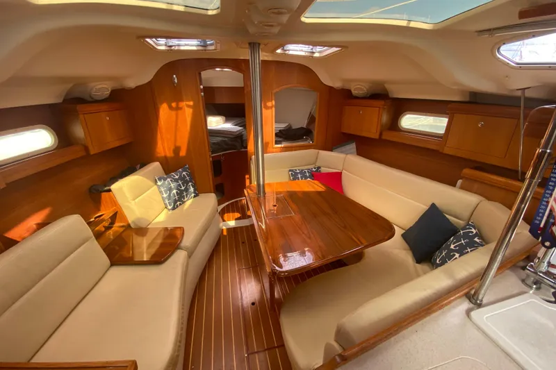 Slide: The Image of Interior of 2003 Hunter 386 sailboat with cozy seating and wooden finishes. - 7