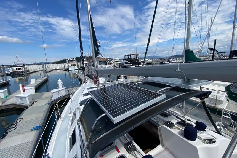 Slide: The Image of 2003 Hunter 386 sailboat with solar panel docked at marina under blue sky. - 70
