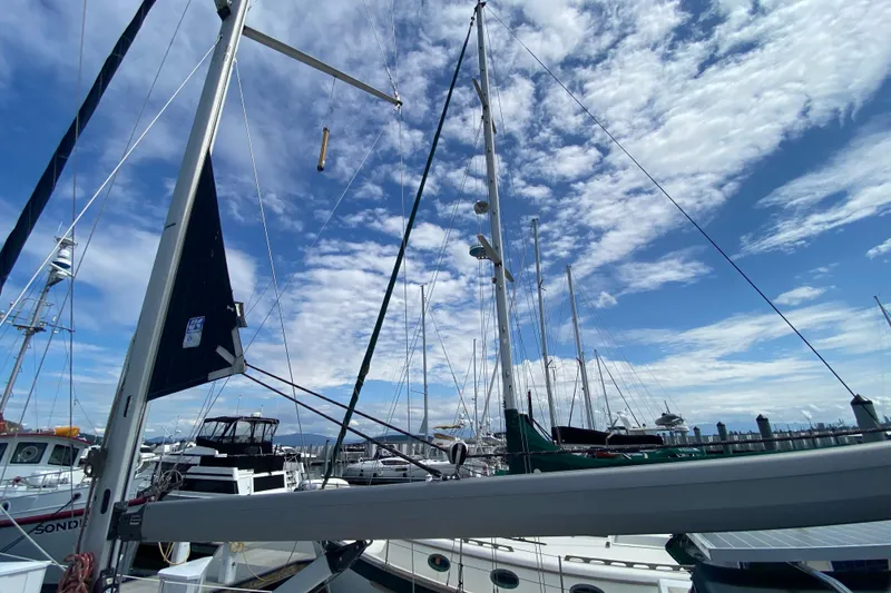 Slide: The Image of Sailboats docked at marina under blue sky, featuring 2003 Hunter 386 model. - 73