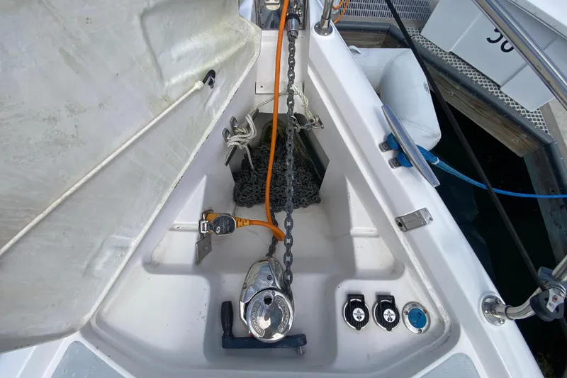 Slide: The Image of Anchor chain compartment on a 2003 Hunter 386 sailboat, docked at a marina. - 75