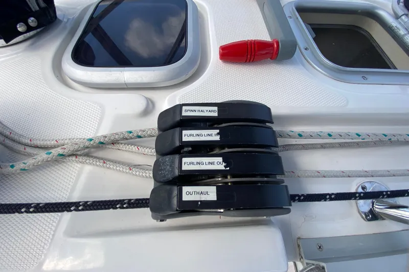 Slide: The Image of Deck of 2003 Hunter 386 sailboat with labeled rope clutches and lines. - 79